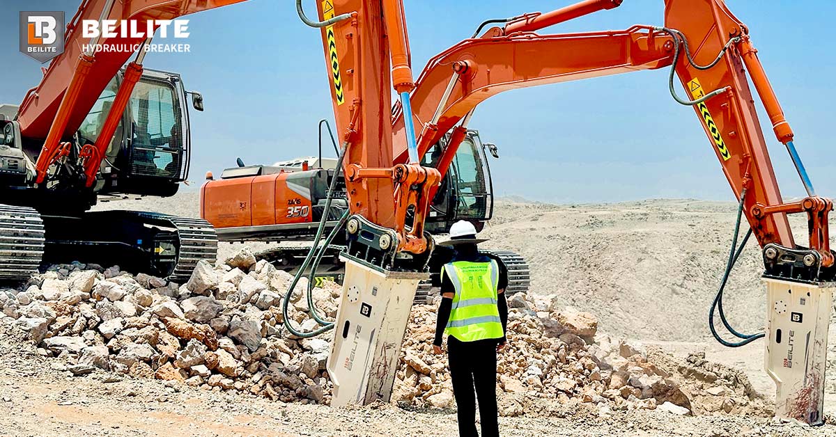 An excavator with a BEILITE hydraulic breaker efficiently breaking large rocks at a quarry face. An excavator with a BEILITE hydraulic breaker efficiently breaking large rocks at a quarry face.